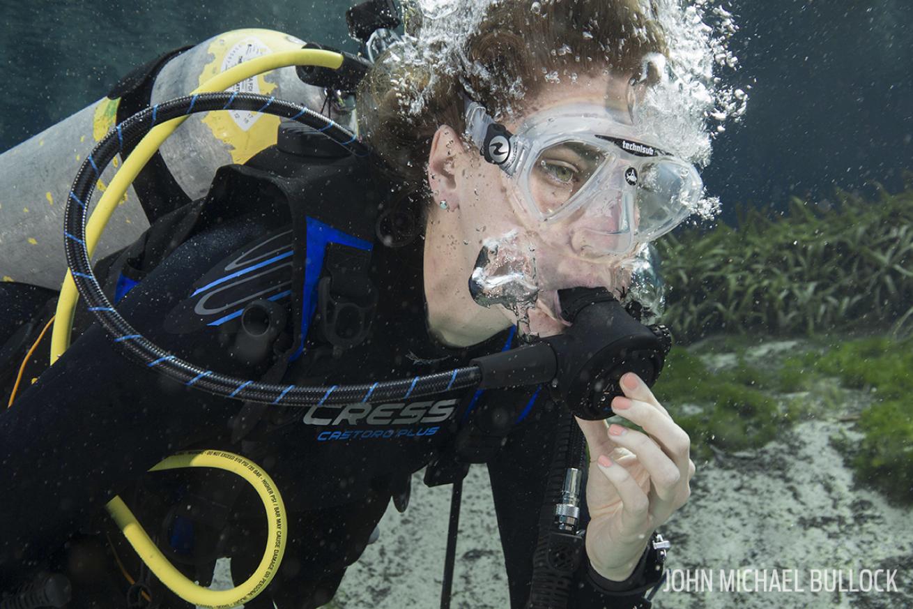 Scuba diver purging regulator at ScubaLab test