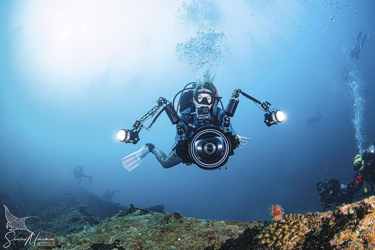 a scuba diver with an underwater camera in the maldives