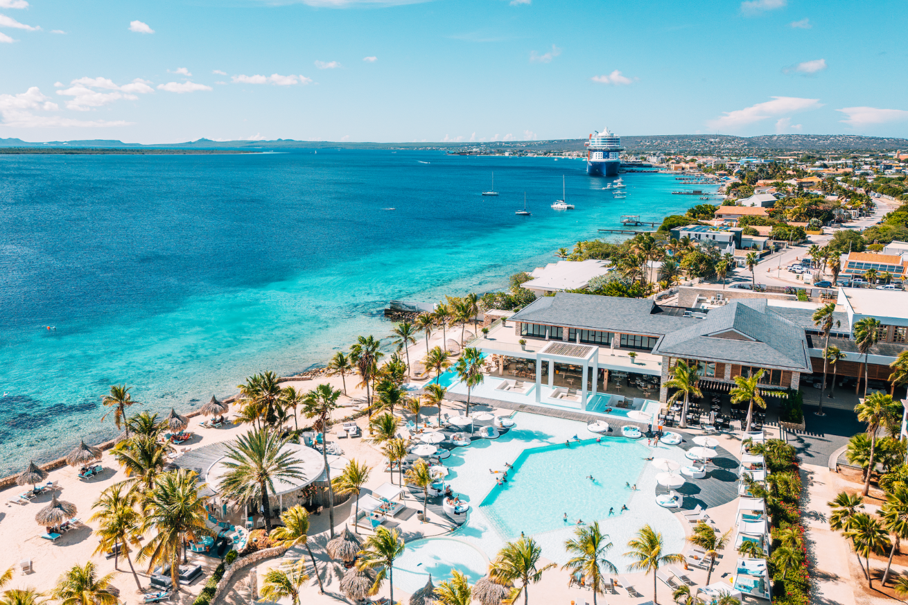 A resort with a pool and a body of water