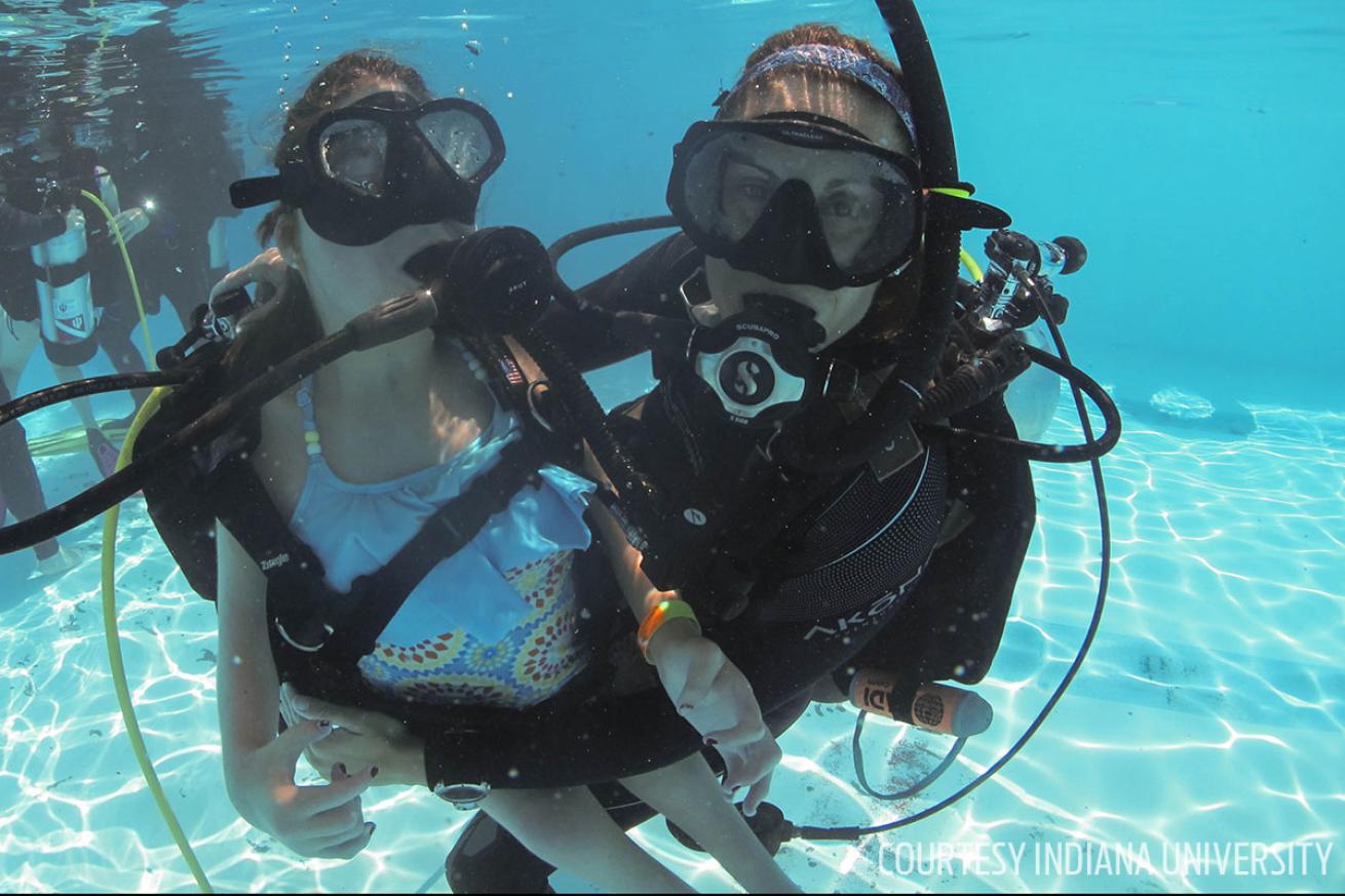 Instructors assist campers during adaptive scuba diving program at Bradford Woods