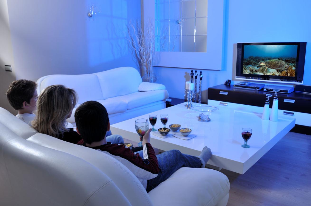Family Watching Ocean Movie on Couch
