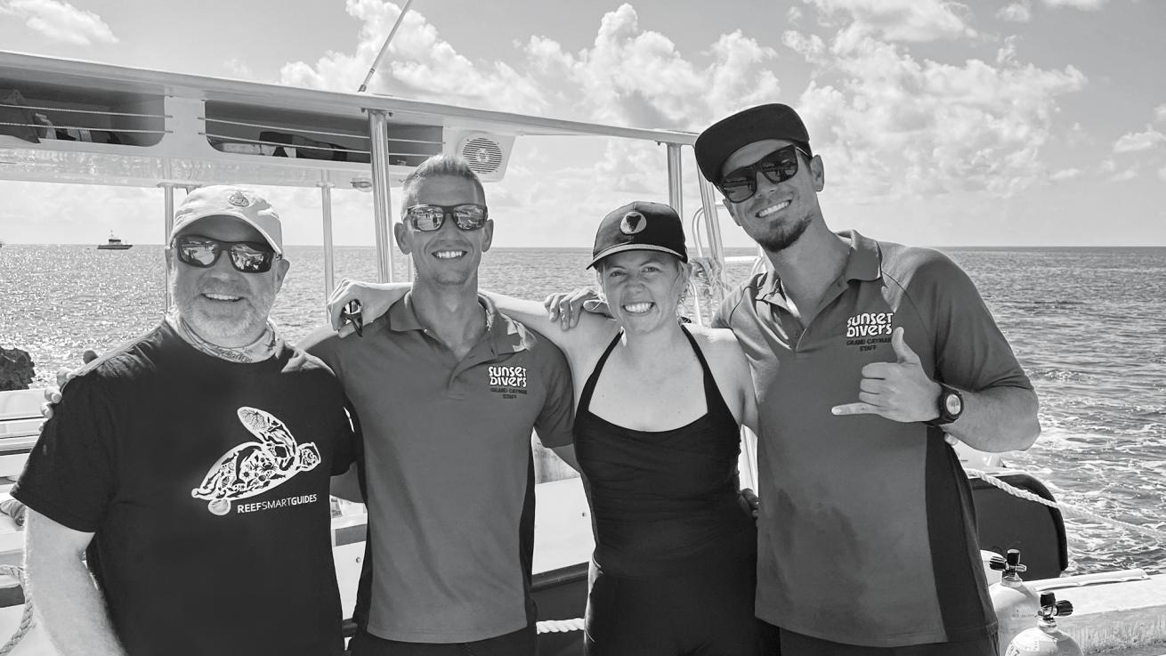 Ian, Tyler, the author and Alex pose alongside one of Sunset House’s dive boats