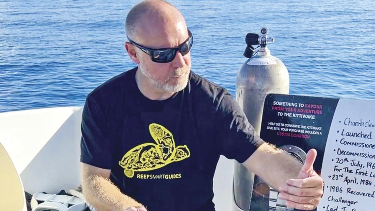 a man gives a presentation on a dive boat 