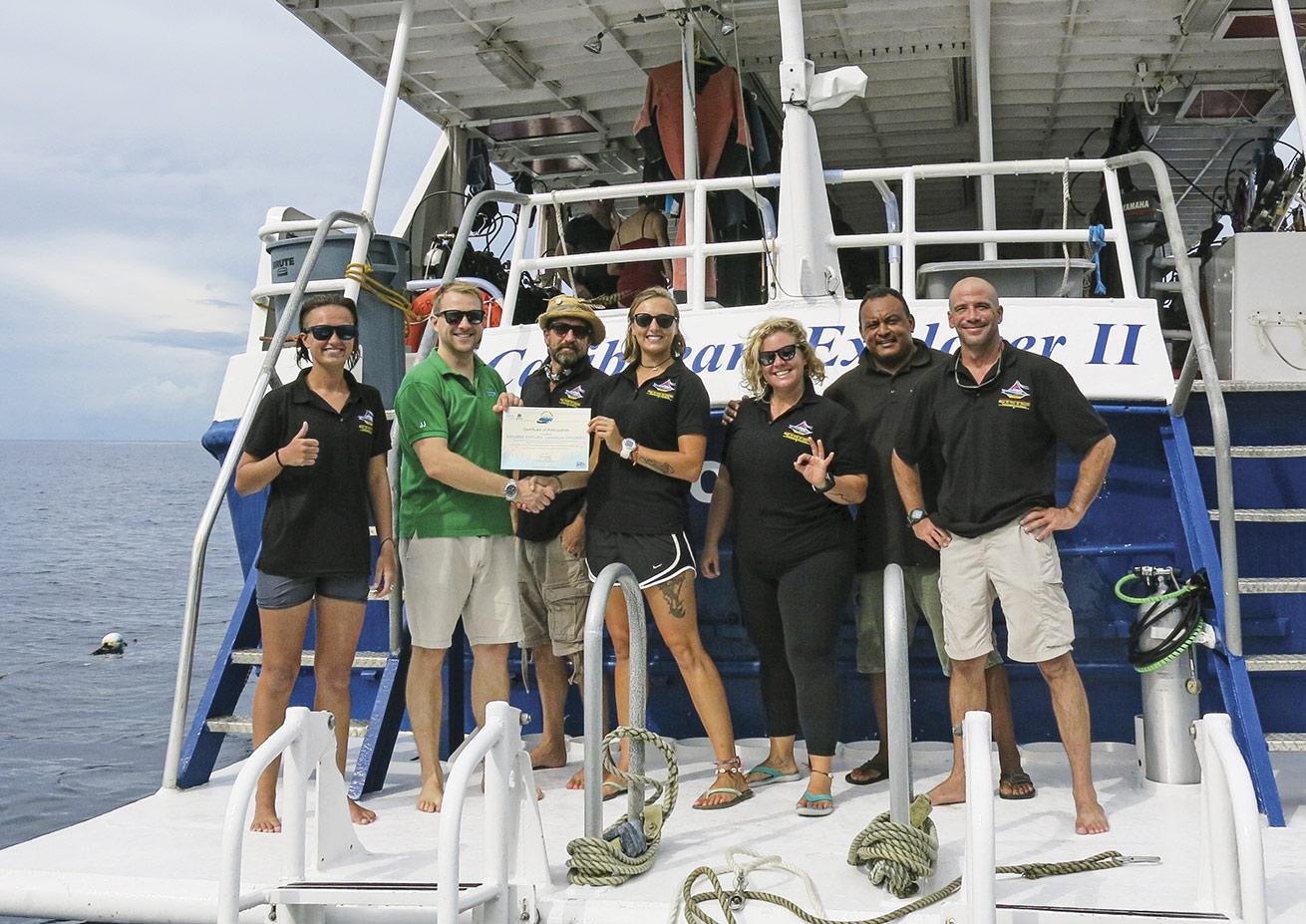 The crew of Caribbean Explorer II shows off the vessel’s Green Fins certification, making it the first liveaboard to receive the distinction.