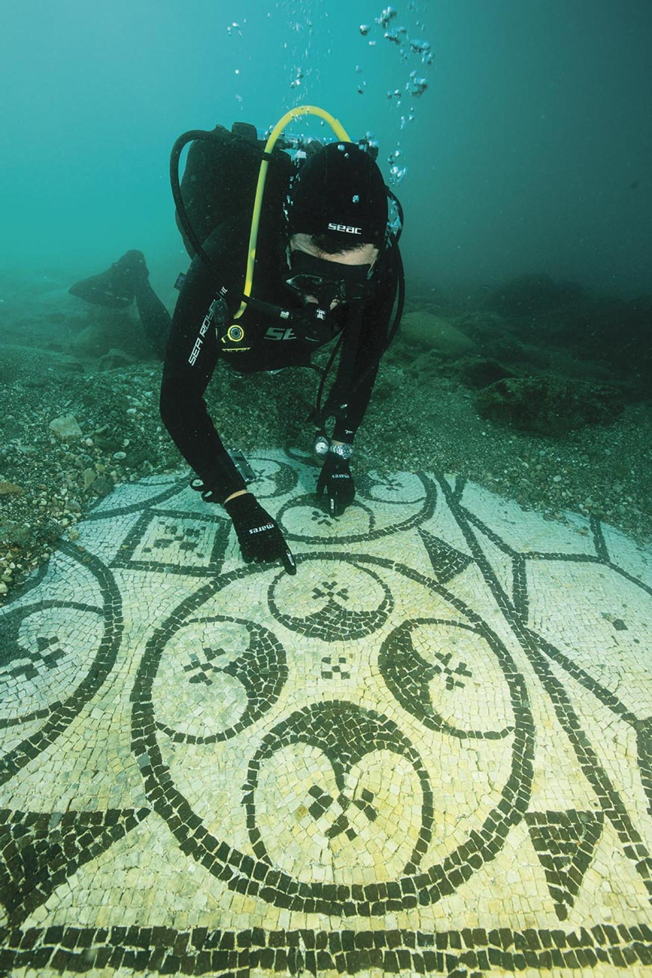 A diver inspects a mosaic in the courtyard of a sunken villa in Baia, Italy.