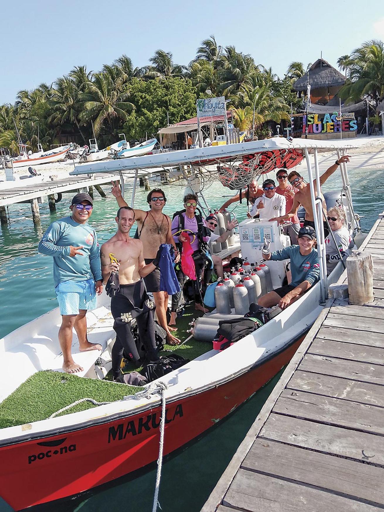 A group of eager divers is ready to explore Isla Mujeres’ crystal-clear waters with Pocna Dive Center.