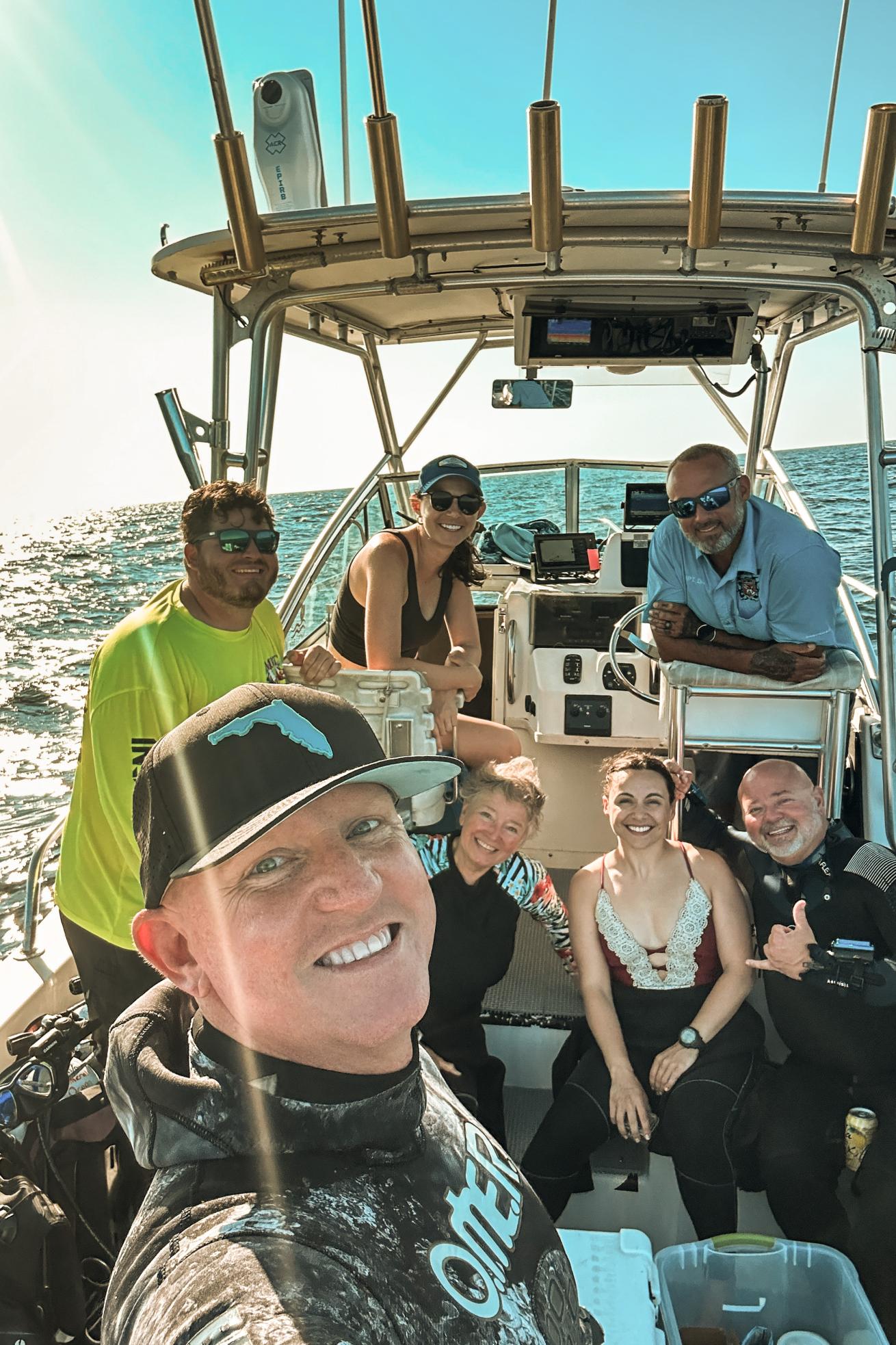 divers smiling on a boat