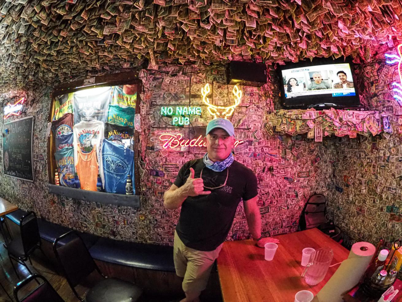 A person standing in front of a wall of money