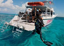 Scuba diver strides into the ocean wearing the latest gear.